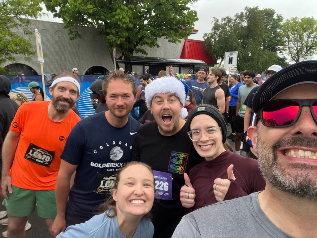 6 people smiling at the starting line of a 10K fun run