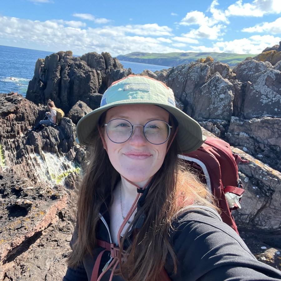 Paige standing in front of a rock formation